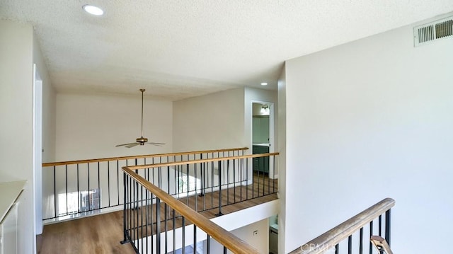 45299 Esmerado Ct, Temecula, CA 92592 - hall featuring a textured ceiling, wood finished floors, an upstairs landing, and recessed lighting
