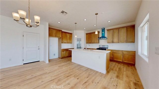 kitchen with stainless steel electric stove, visible vents, brown cabinetry, and wall chimney range hood