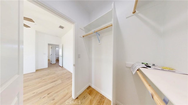 spacious closet with visible vents and light wood-type flooring