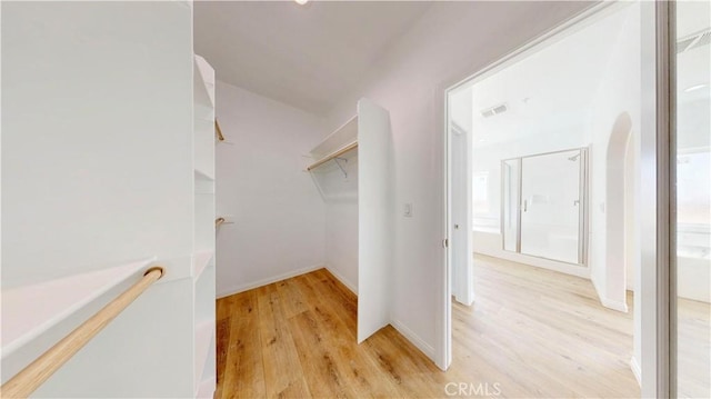 spacious closet featuring light wood finished floors and visible vents