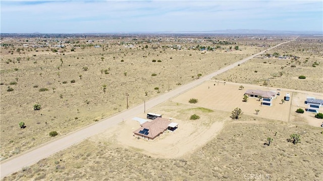 birds eye view of property featuring a rural view and a desert view