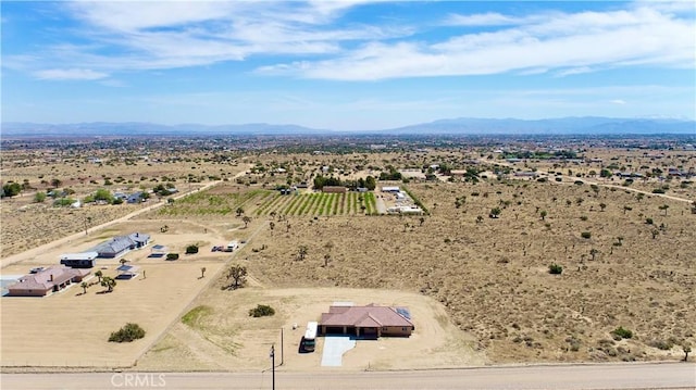 aerial view featuring a rural view, a desert view, and a mountain view