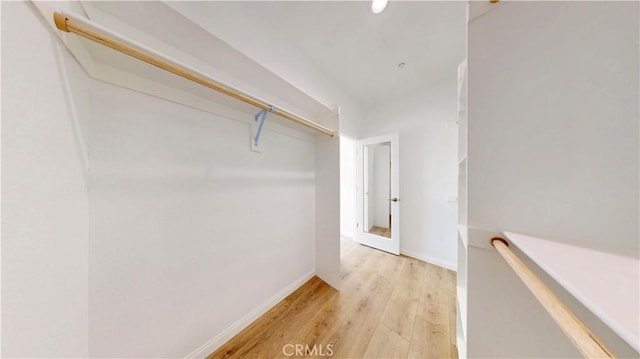 walk in closet featuring light wood-style flooring