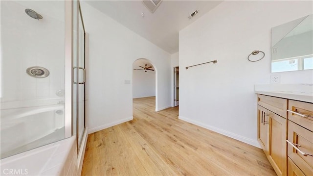 bathroom with lofted ceiling, visible vents, an enclosed shower, vanity, and a bathtub