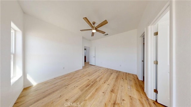unfurnished bedroom with light wood finished floors, a ceiling fan, and visible vents