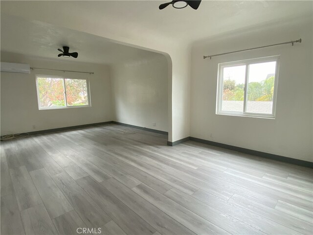 5101 Lindsey Ave, Pico Rivera, CA 90660 - unfurnished room with healthy amount of natural light, arched walkways, and wood finished floors