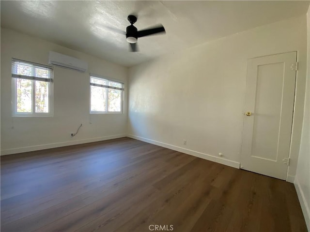 5101 Lindsey Ave, Pico Rivera, CA 90660 - empty room featuring a wall mounted AC, dark wood-style flooring, and baseboards