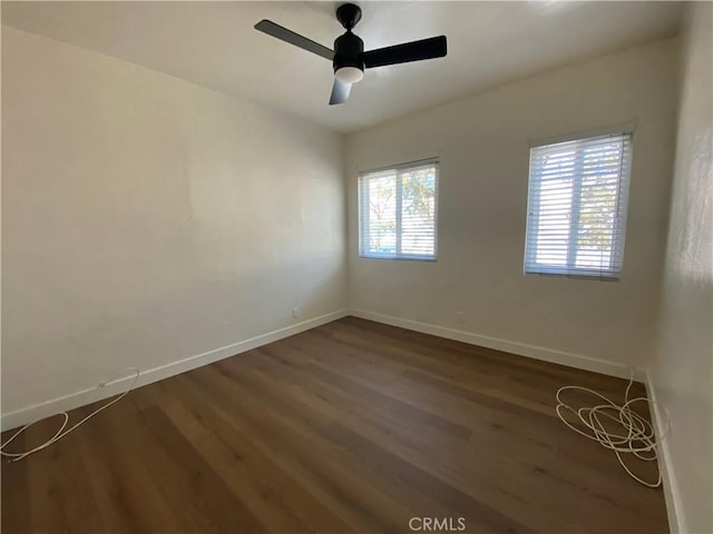 5101 Lindsey Ave, Pico Rivera, CA 90660 - unfurnished room with baseboards, dark wood-style flooring, and ceiling fan