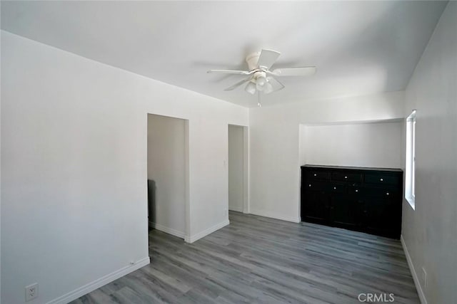 5101 Lindsey Ave, Pico Rivera, CA 90660 - unfurnished bedroom with wood finished floors, baseboards, and a ceiling fan