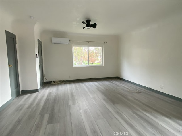 5101 Lindsey Ave, Pico Rivera, CA 90660 - spare room featuring a wall mounted air conditioner, wood finished floors, and baseboards
