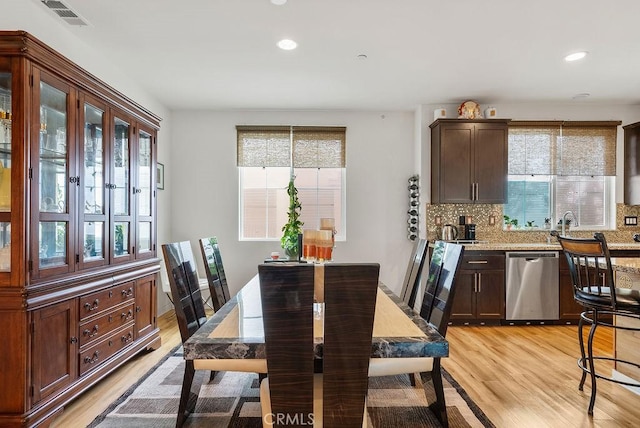 dining room featuring light wood-type flooring, visible vents, and recessed lighting
