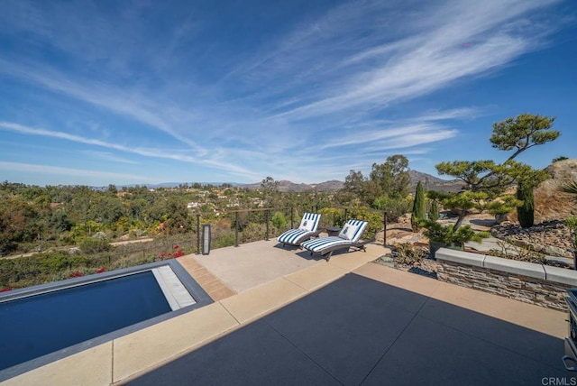 view of pool featuring a patio and a mountain view