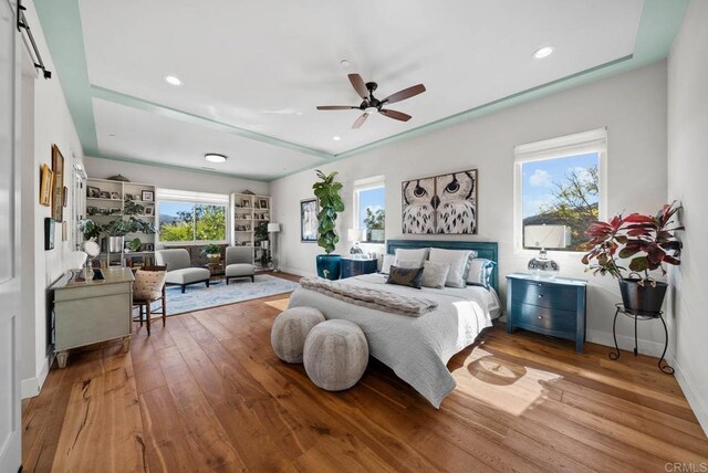 bedroom with baseboards, recessed lighting, ceiling fan, and wood-type flooring
