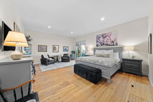 bedroom featuring baseboards, recessed lighting, and light wood-style flooring