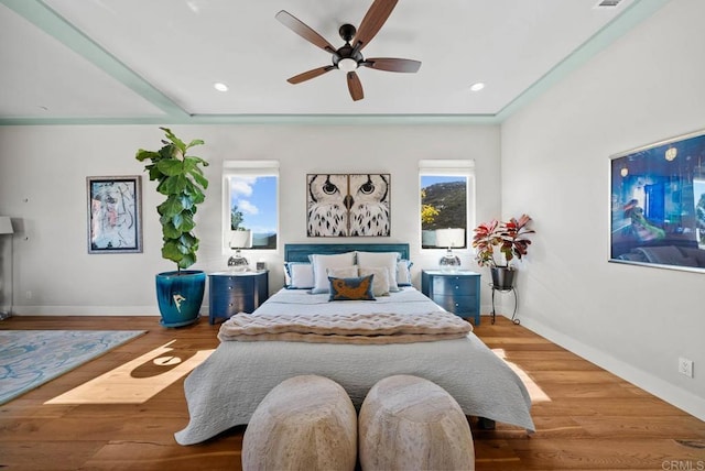bedroom featuring baseboards, recessed lighting, wood finished floors, and ceiling fan