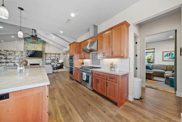 kitchen with stainless steel appliances, wall chimney range hood, visible vents, a ceiling fan, and open floor plan