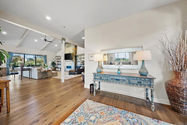 interior space with wood finished floors, ceiling fan, recessed lighting, and vaulted ceiling with beams