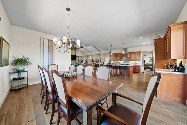 dining room featuring a chandelier, recessed lighting, baseboards, and light wood-style floors