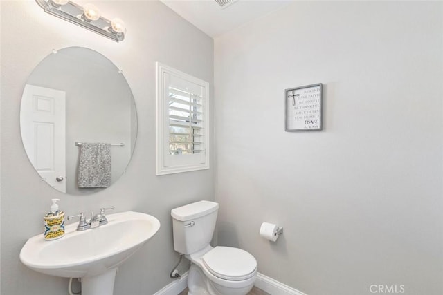 14917 Landerwood Dr, Eastvale, CA 92880 - bathroom with a sink, toilet, and baseboards