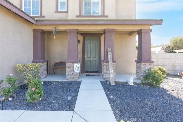14917 Landerwood Dr, Eastvale, CA 92880 - property entrance featuring stucco siding, a porch, and stone siding