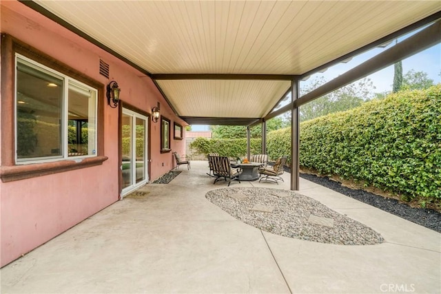 view of patio with visible vents and fence