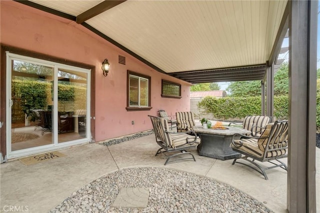 view of patio with visible vents and a fire pit