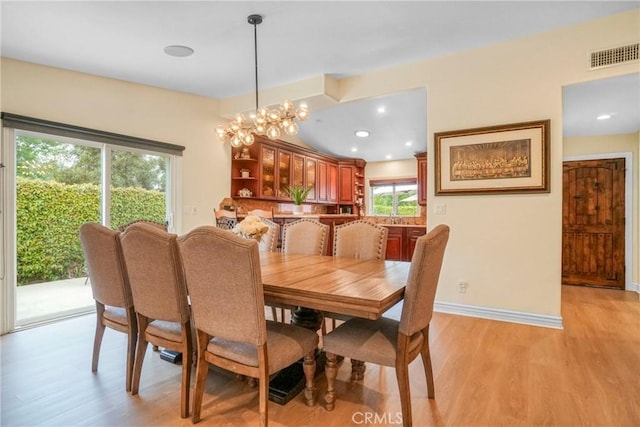 dining space featuring light wood finished floors, baseboards, visible vents, and recessed lighting