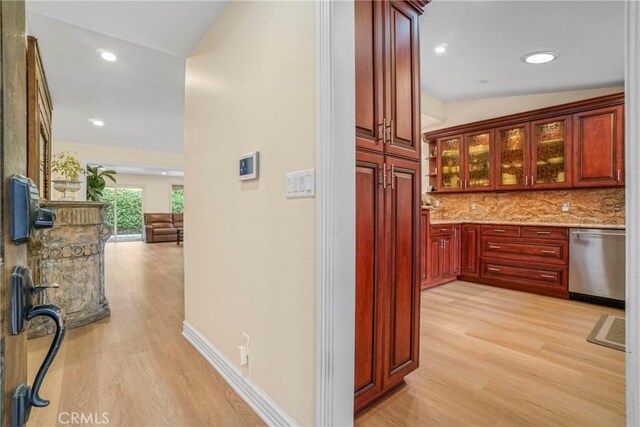 hallway with recessed lighting, light wood-style floors, and lofted ceiling