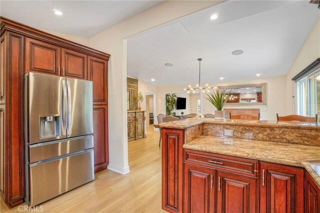 18750 Keswick St, Reseda, CA 91335 - kitchen with stainless steel fridge, light wood-type flooring, open floor plan, vaulted ceiling, and light stone countertops