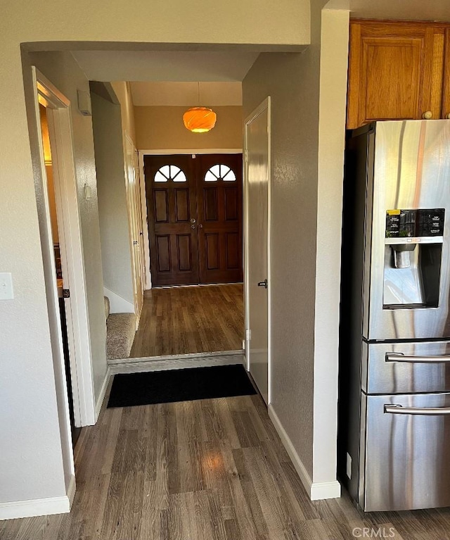interior space with baseboards and dark wood-style flooring