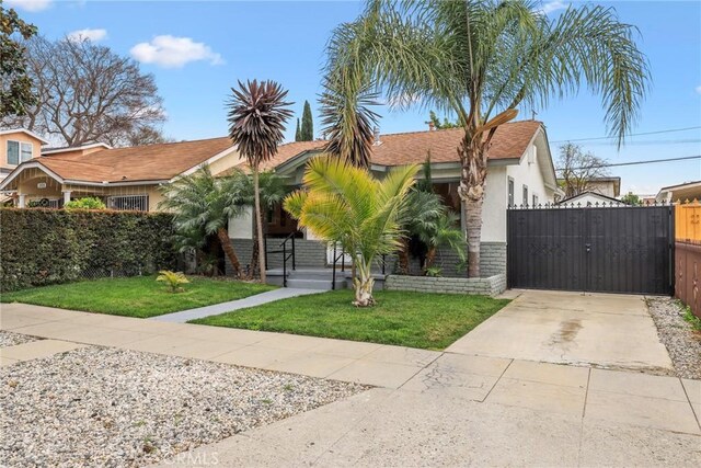 2410 Exposition Pl, Los Angeles, CA 90018 - view of front of house featuring a gate, concrete driveway, and stucco siding