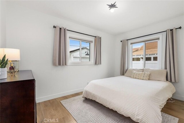 2410 Exposition Pl, Los Angeles, CA 90018 - bedroom with multiple windows and light wood-type flooring