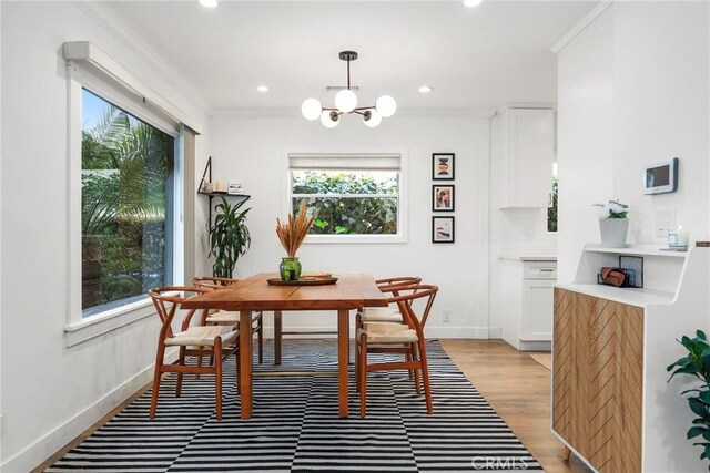 2410 Exposition Pl, Los Angeles, CA 90018 - dining area featuring recessed lighting, a chandelier, crown molding, and light wood-style flooring