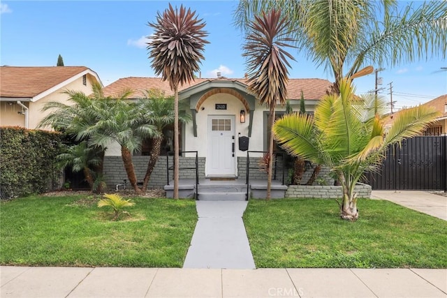 2410 Exposition Pl, Los Angeles, CA 90018 - view of front of property with stucco siding and a front lawn