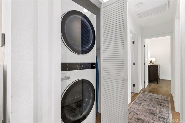 2410 Exposition Pl, Los Angeles, CA 90018 - washroom with estacked washer and dryer, attic access, and wood finished floors