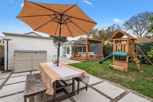 2410 Exposition Pl, Los Angeles, CA 90018 - view of patio with an outdoor living space, a playground, and outdoor dining space