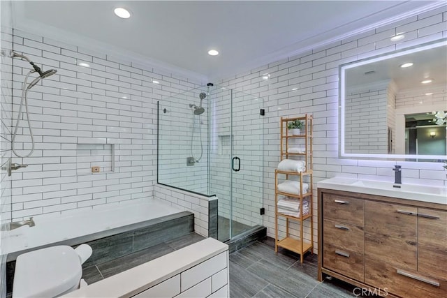 bathroom featuring vanity, a bathing tub, recessed lighting, tile walls, and a shower stall