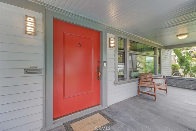 view of exterior entry featuring a porch