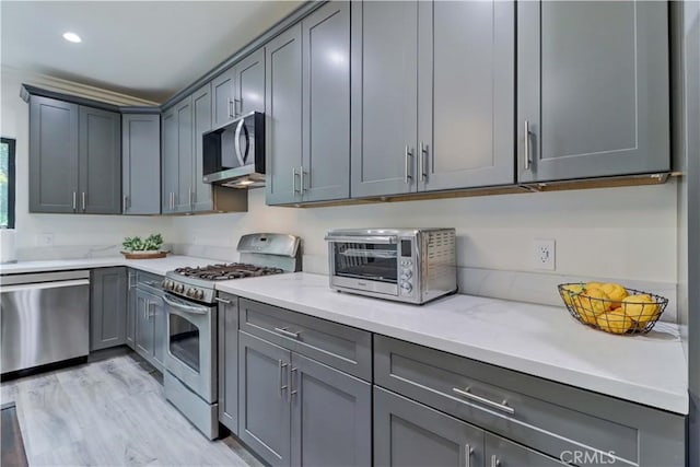 223 N St Andrews Pl, Los Angeles, CA 90004 - kitchen featuring stainless steel appliances, gray cabinetry, light stone countertops, and recessed lighting