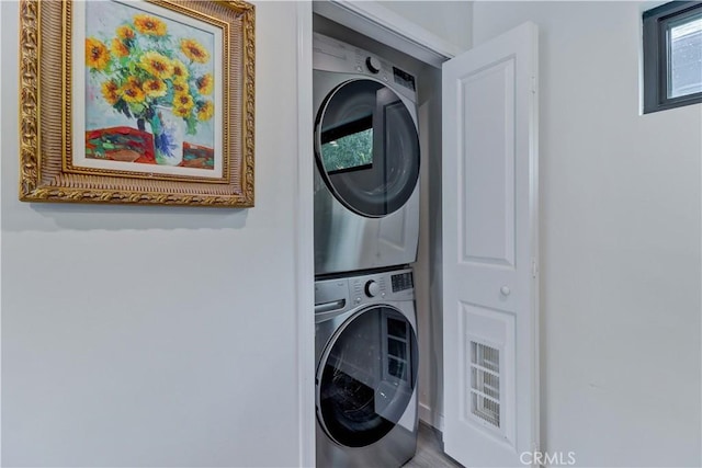 laundry area with laundry area and stacked washer and dryer