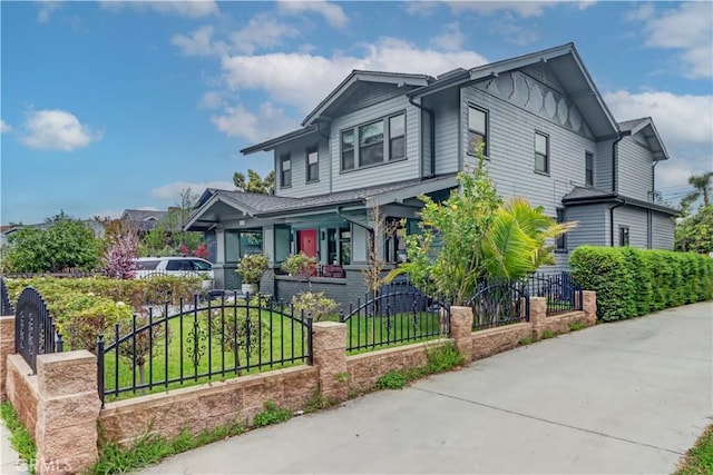223 N St Andrews Pl, Los Angeles, CA 90004 - craftsman inspired home with covered porch, a fenced front yard, and board and batten siding