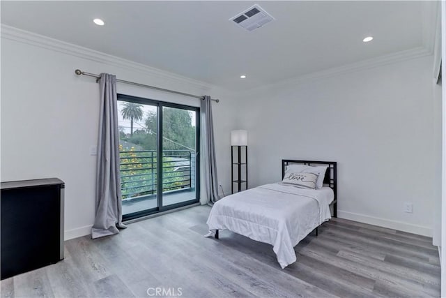 bedroom featuring access to outside, ornamental molding, wood finished floors, and visible vents