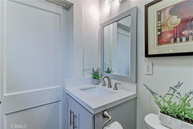 half bathroom with toilet and vanity