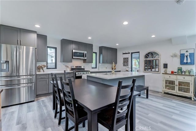 dining space featuring light wood-style floors, plenty of natural light, and recessed lighting
