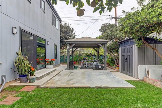 view of patio featuring a storage shed, fence, an outdoor structure, and a gazebo