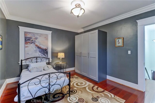 223 N St Andrews Pl, Los Angeles, CA 90004 - bedroom with wood finished floors, ornamental molding, and a closet