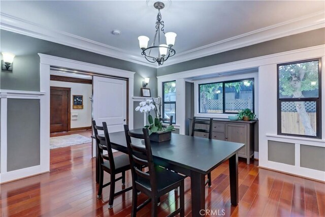 223 N St Andrews Pl, Los Angeles, CA 90004 - dining room featuring a chandelier, dark wood-style flooring, and crown molding