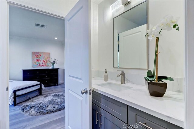 223 N St Andrews Pl, Los Angeles, CA 90004 - bathroom featuring vanity, wood finished floors, and ornamental molding