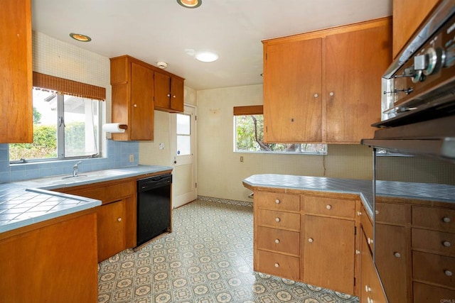 557 Canyon Dr, Solana Beach, CA 92075 - kitchen featuring black dishwasher, tile counters, a sink, and brown cabinets