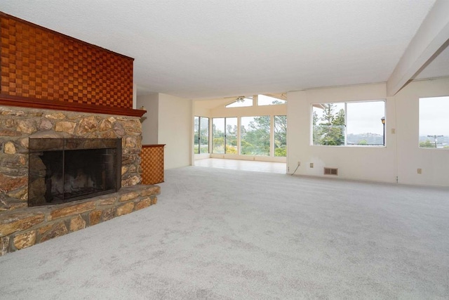 557 Canyon Dr, Solana Beach, CA 92075 - unfurnished living room featuring carpet floors, a stone fireplace, plenty of natural light, and a ceiling fan